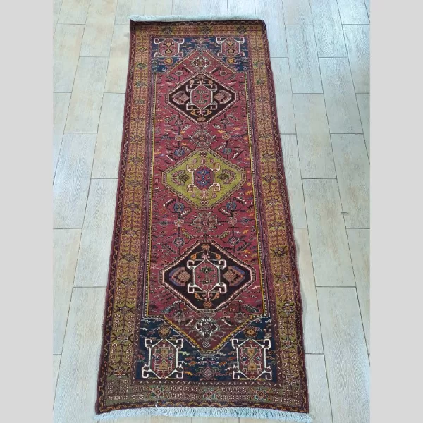 A full view of a beautifully crafted Persian Qashqai runner, highlighting its vibrant colors and intricate design.