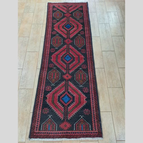 Complete view of a handmade Persian Baluch runner featuring traditional geometric designs.