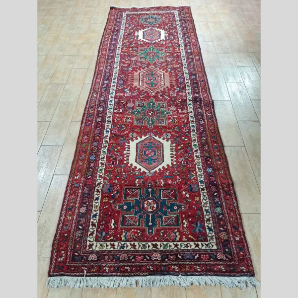 Full view of a handmade Persian runner with intricate floral patterns.