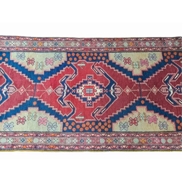 Close-up of the vibrant patterns and texture of the Persian Afshar runner