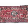 View of the knot style and density in the Persian Qashqai runner, showcasing traditional weaving techniques.
