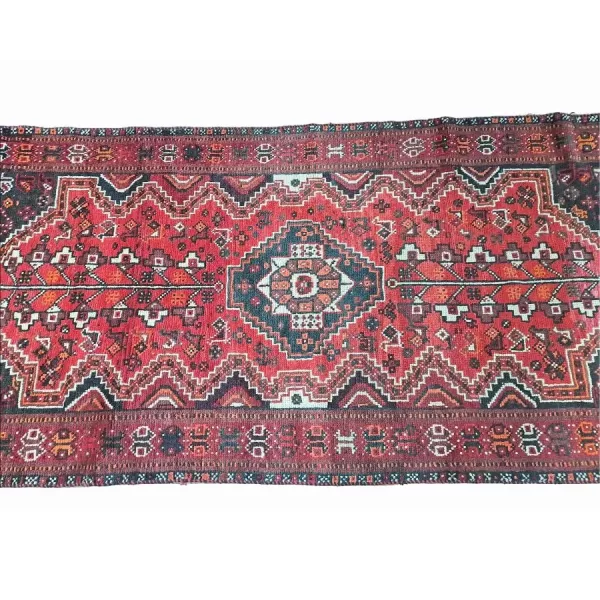 View of the knot style and density in the Persian Qashqai runner, showcasing traditional weaving techniques.