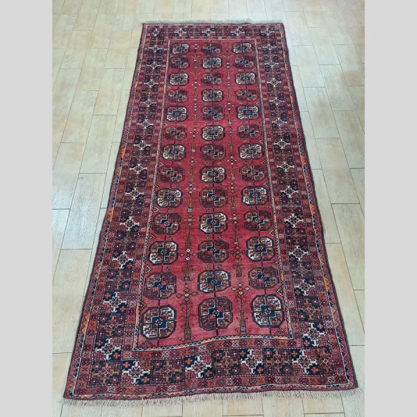 Full display of the handmade Persian Baluch runner with traditional patterns